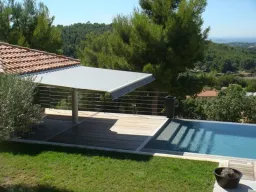 Store banne cassette électrique aux lignes raffinées qui se distingue par son lambrequin enroulable intégré et protégé dans la barre de charge et par son éclairage à LED intégré aux bras.